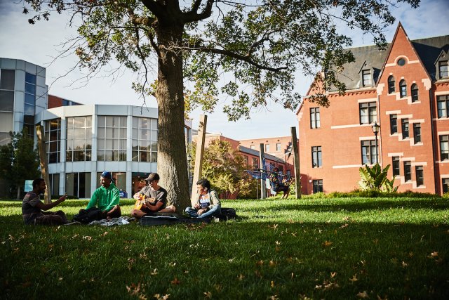 Students on the lawn outside of Pius Library